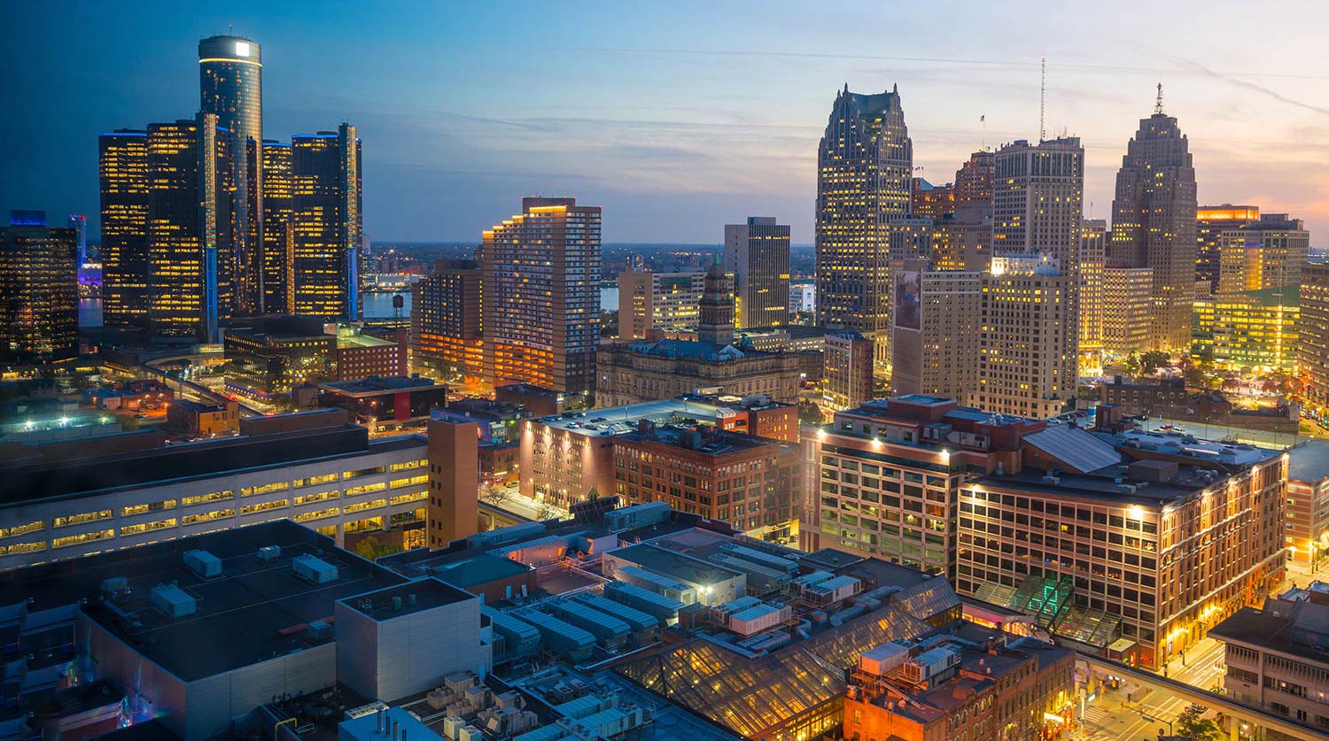 Illuminated buildings in downtown Detroit at dusk