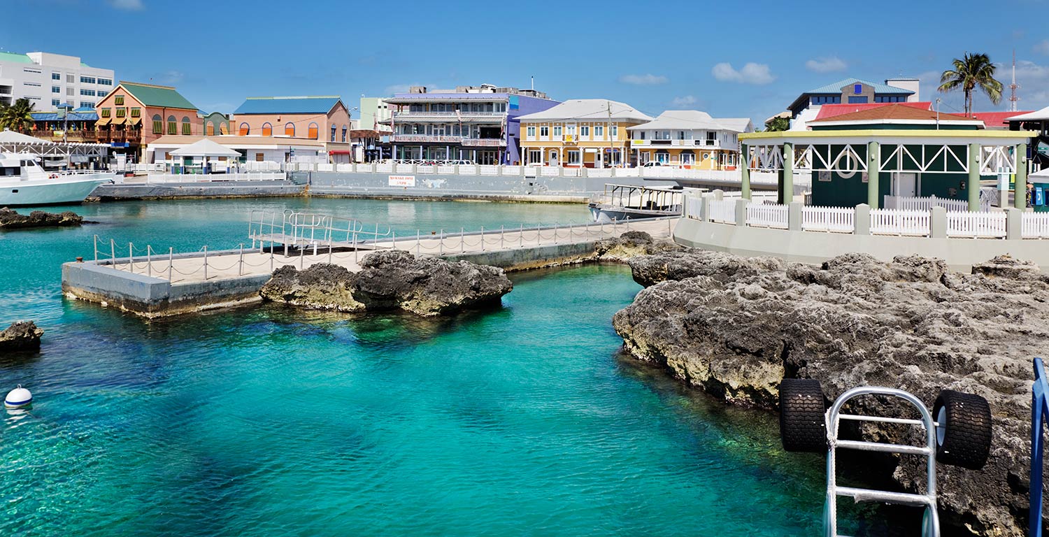 Rocky waterfront with brightly colored buildings in George Town